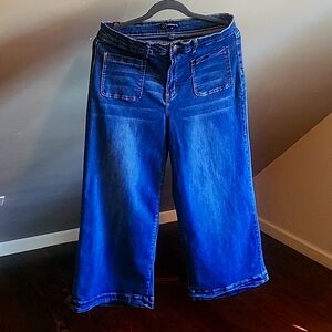 Denim blue jeans.  High waisted. Length comes just above your ankles.